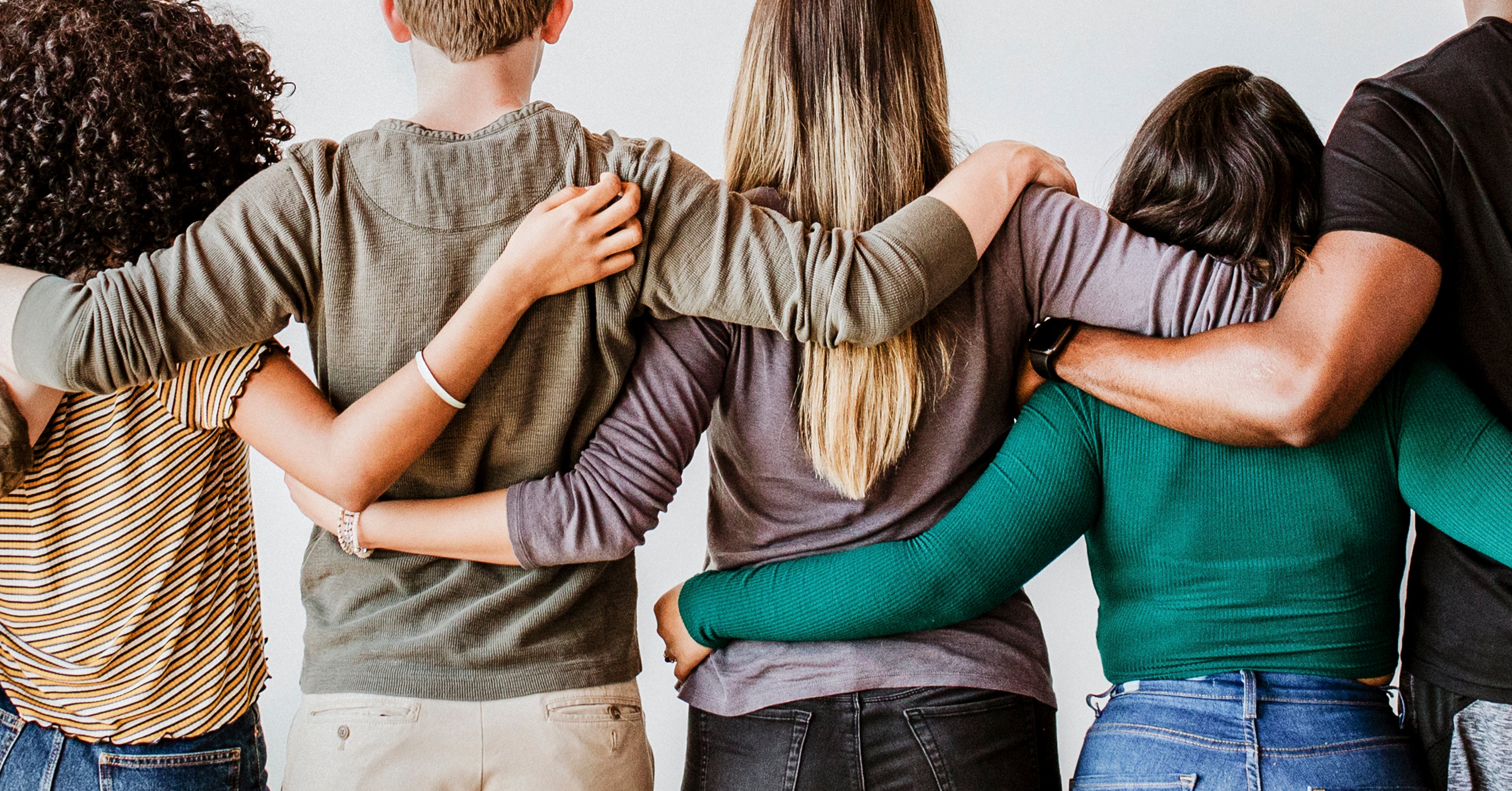 Group of people with arms around each other